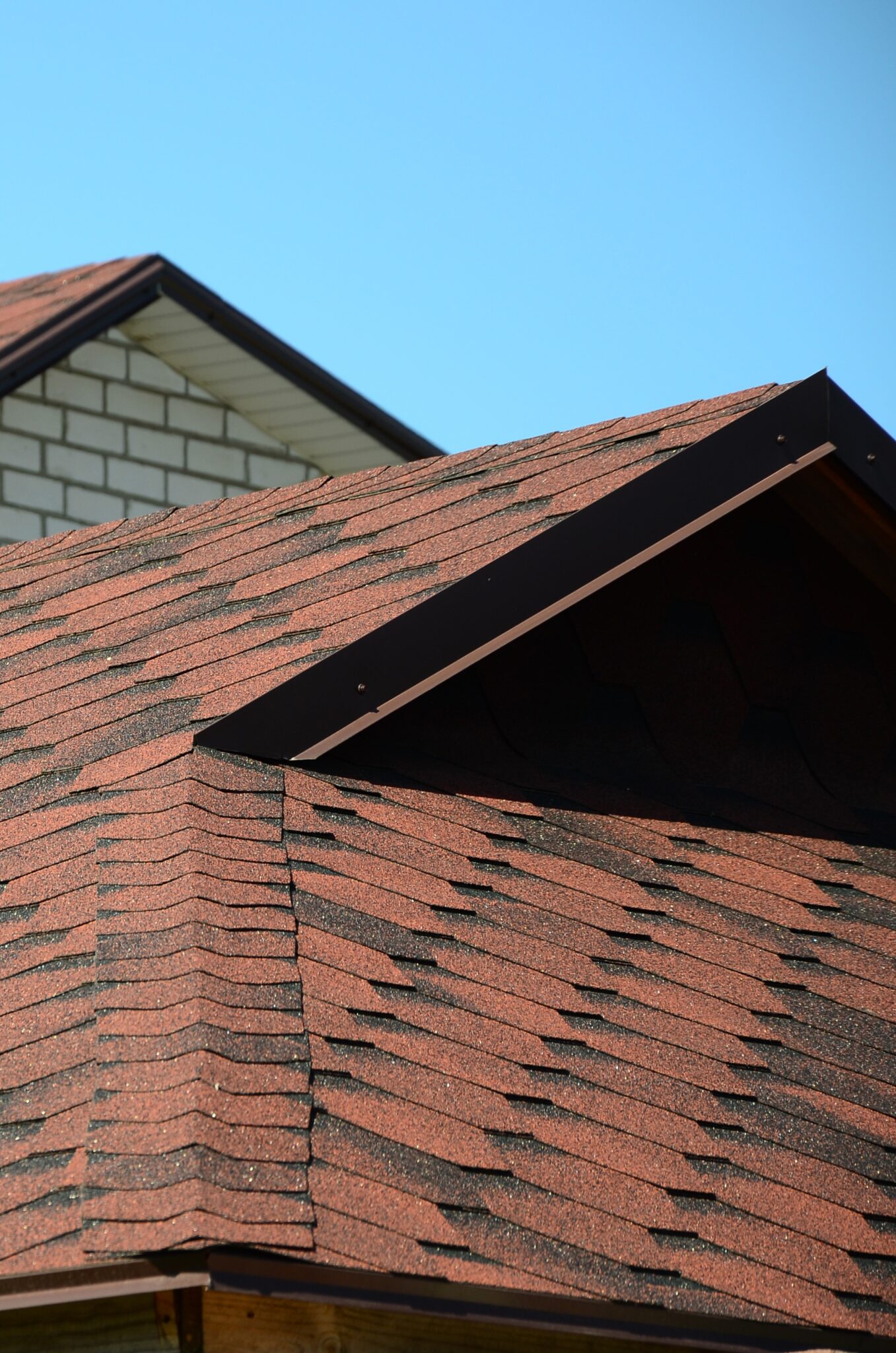 The roof is covered with bituminous shingles of brown color.