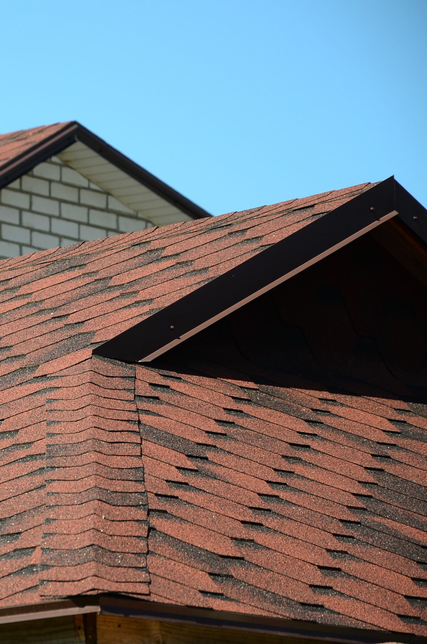 The roof is covered with bituminous shingles of brown color.