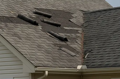 shingles lifting off a residential asphalt roof